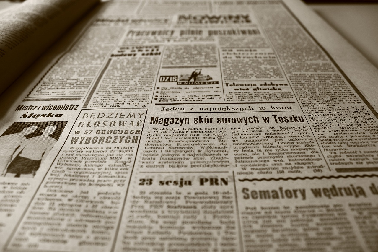 Periódico viejo, Periódico y Retro Fotografía en blanco y negro de un periódico abierto sobre una mesa blanca. Se ve la página derecha, como si fuéramos los lectores. Parece antiguo por la tipografía y las fotografías. Está en polaco.